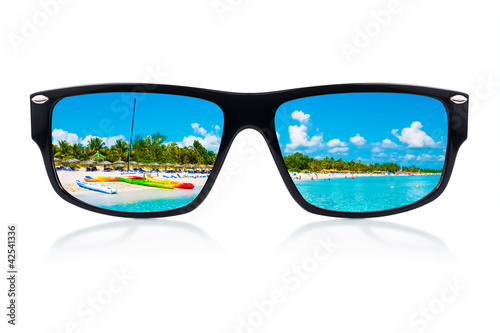 Sunglasses with reflections of a tropical beach