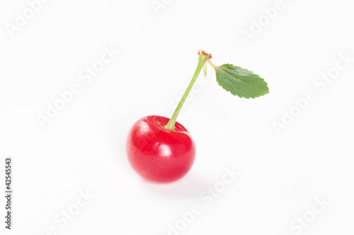 cherry with green leaf on white background