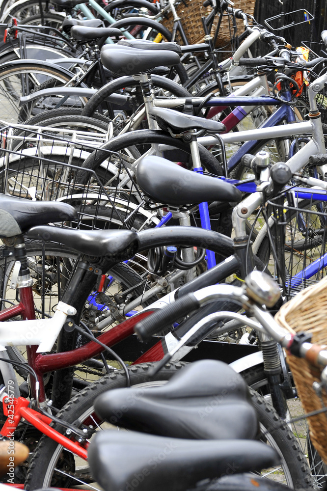 A tangle of bicycles leaning on each other in a university town A tangle of bicycles leaning on each other in a university town