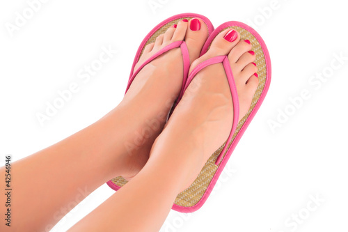 Female feet with flip-flops, isolated on white background.