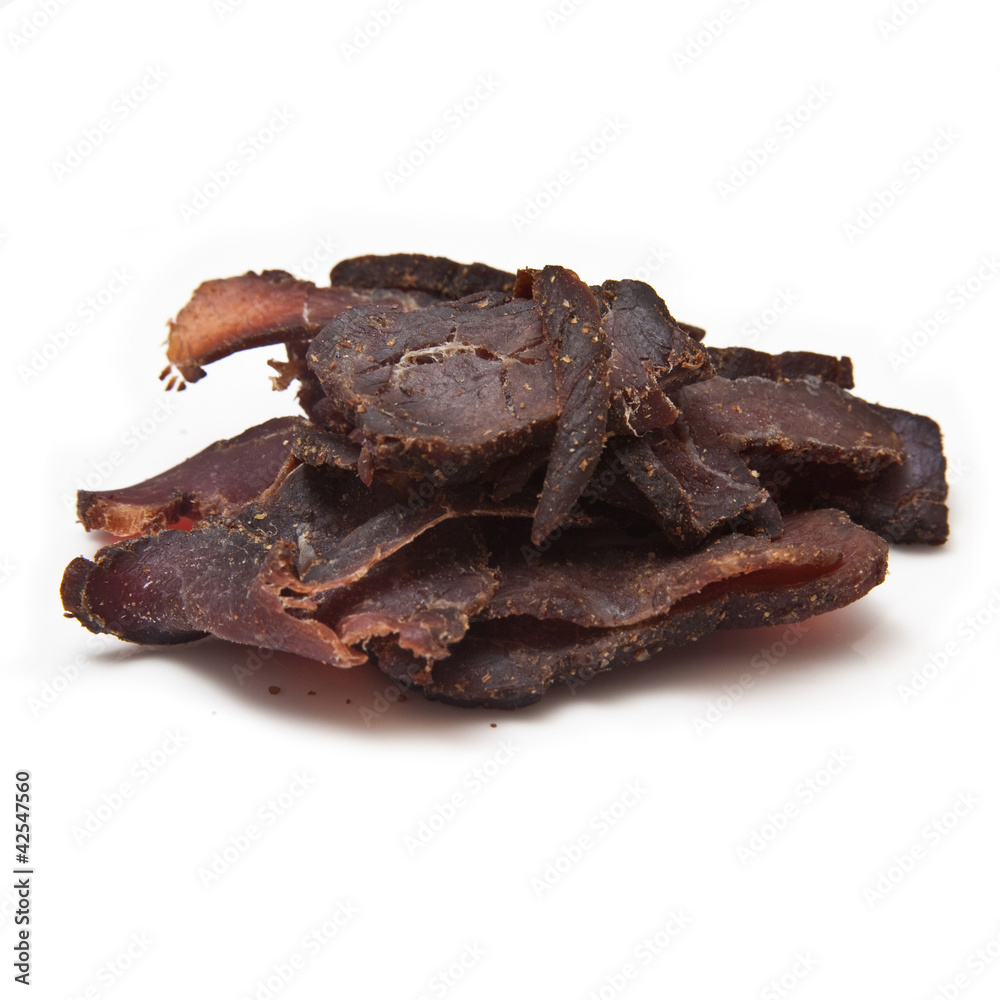 Biltong-(beef jerky) isolated on a white studio background. Biltong-(beef jerky) isolated on a white studio background.