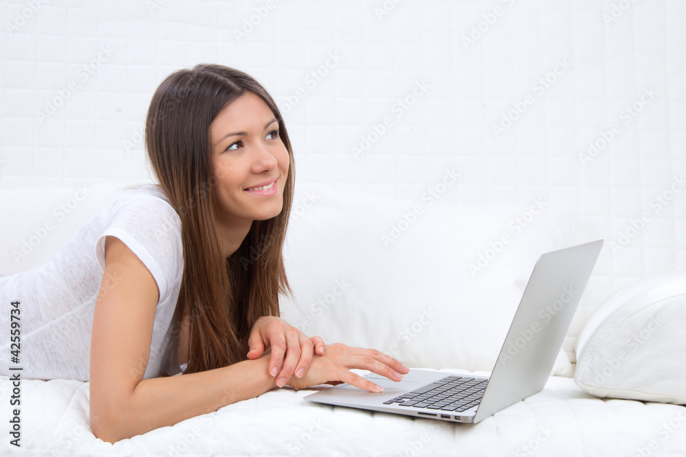successful woman lying on a sofa with laptop successful woman lying on a sofa with laptop