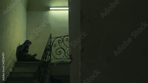 Young drug addict shooting up heroin in abandoned house