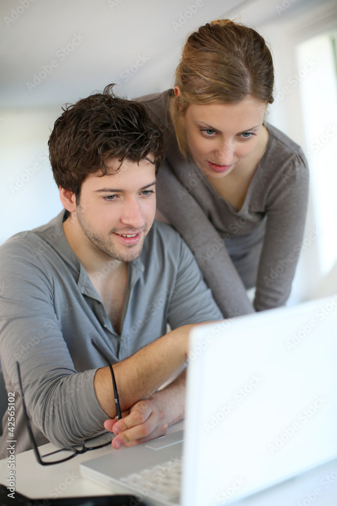 Young people studying from home with laptop computer Young people studying from home with laptop computer
