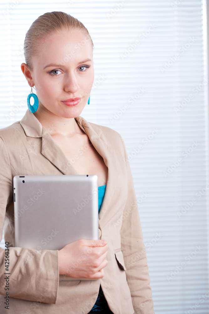 beautiful young positive business woman/student using a tablet o beautiful young positive business woman/student using a tablet o