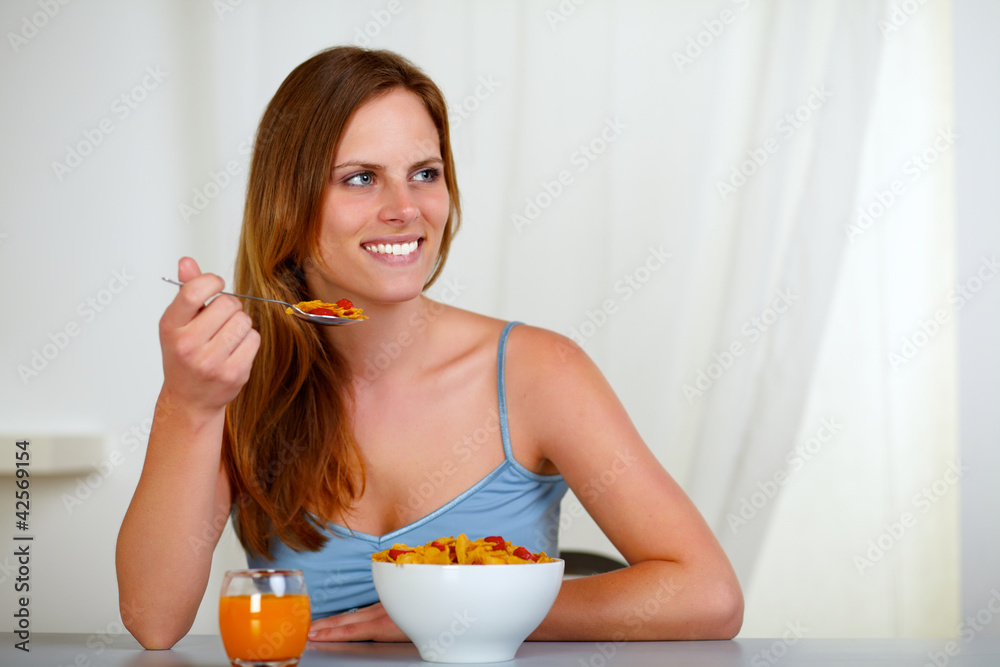 Beautiful blonde young woman eating breakfast Beautiful blonde young woman eating breakfast