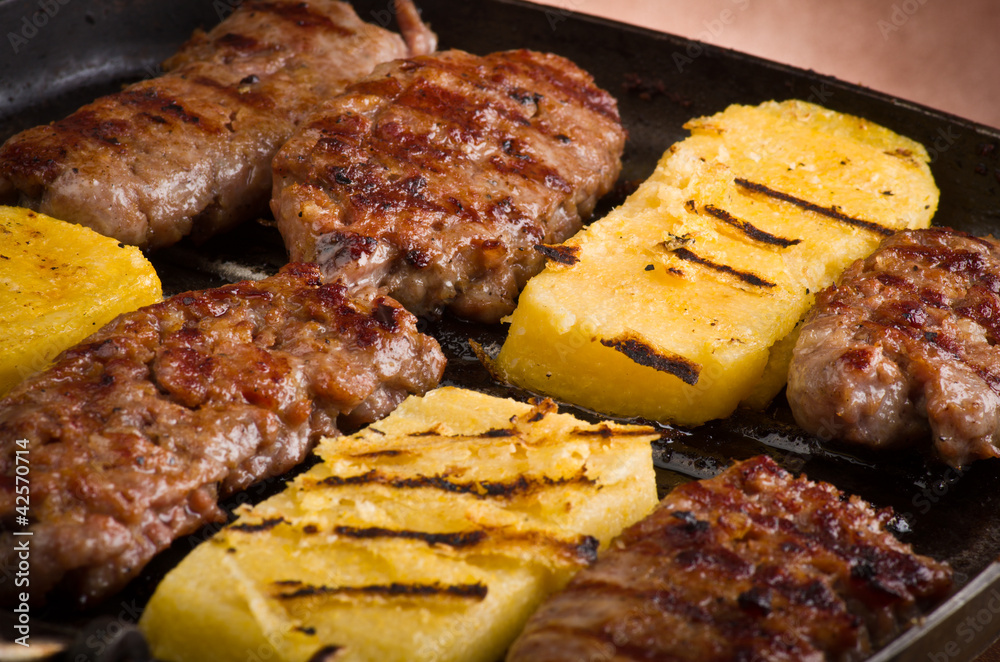 Sausage and sliced of polenta Sausage and sliced of polenta