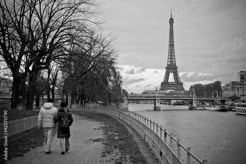 Couple Walking along La Seine with Eiffel Tower in view