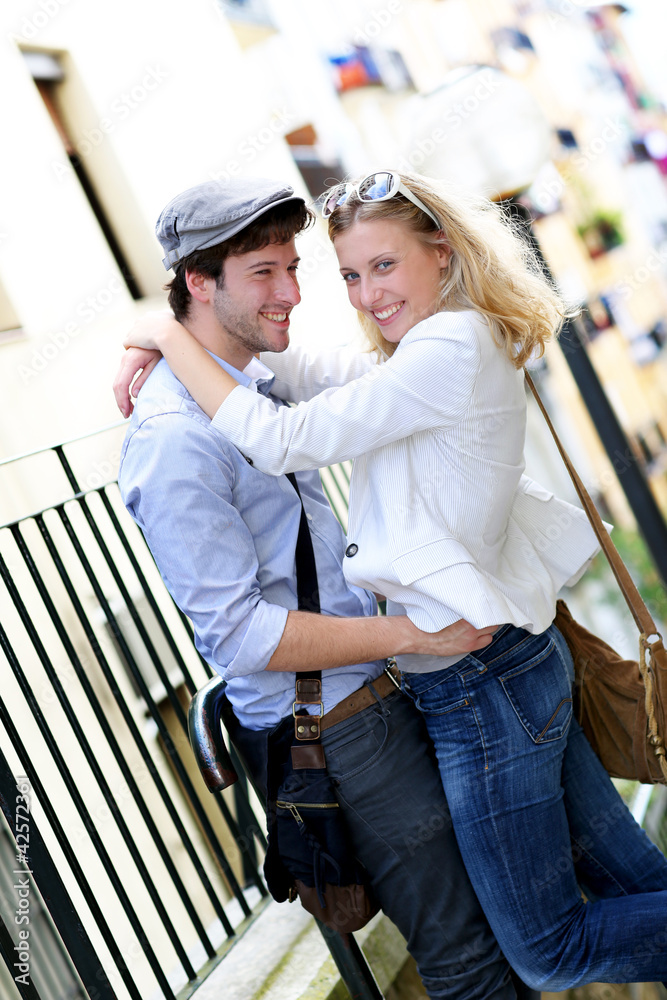 Young in love couple embracing each other in town
