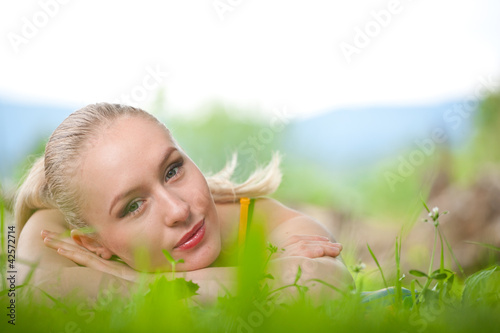 portrait of young beautiful positive woman lying and relaxing in