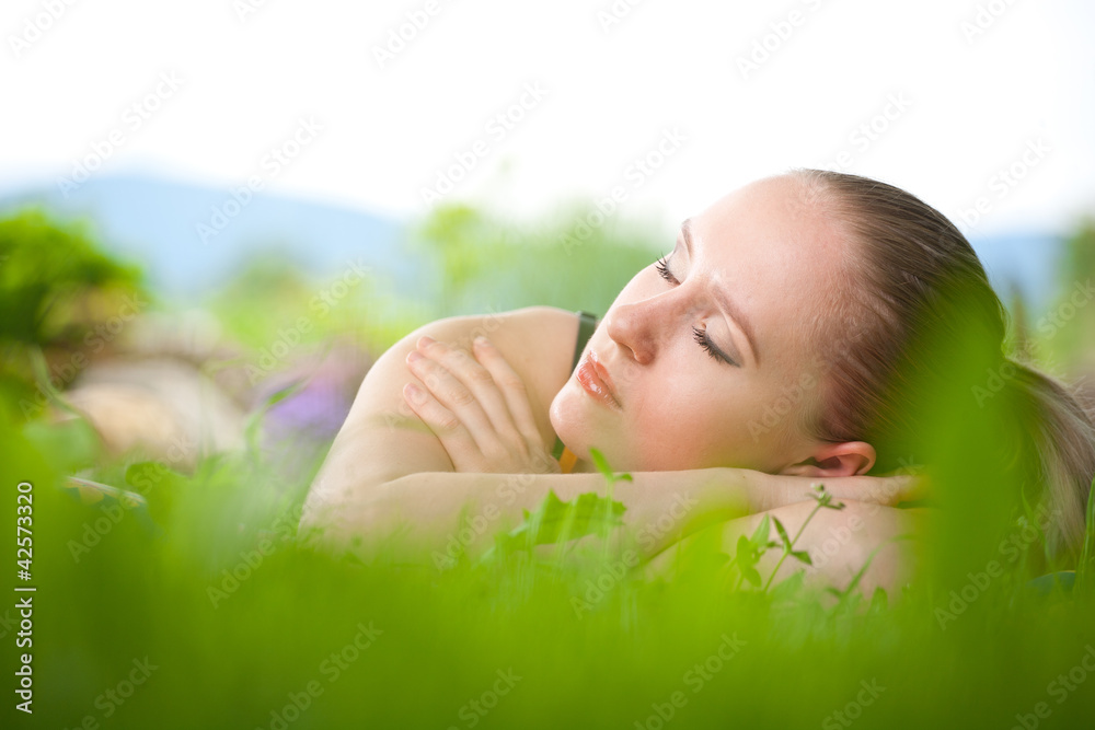portrait of young beautiful positive woman lying and relaxing in portrait of young beautiful positive woman lying and relaxing in