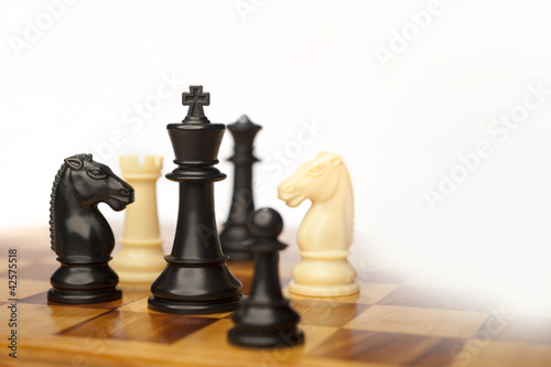 chess pieces on white photo