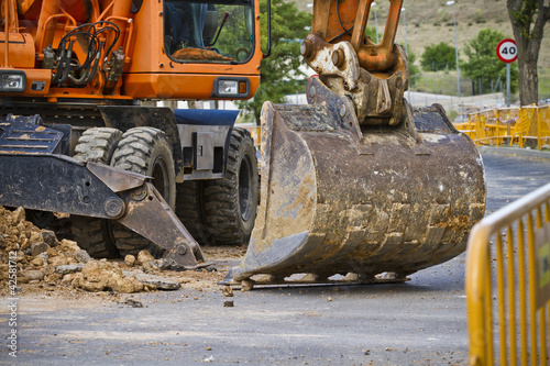 Closeup skid steer loader excavator at road construction work