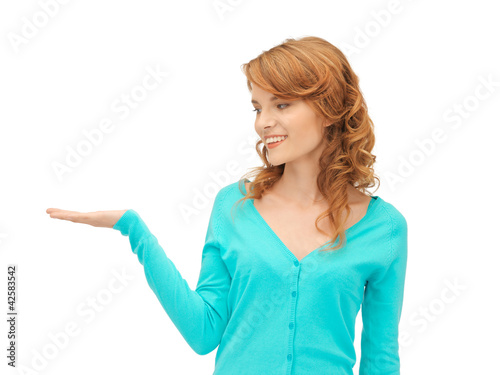 girl showing something on the palm of her hand