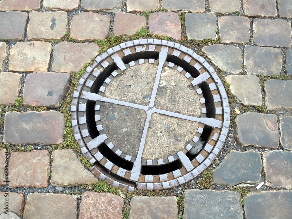 rock ground with an iron manhole cover
