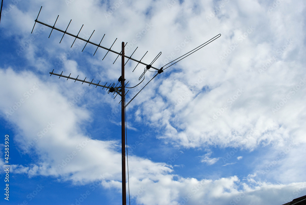 Home advance TV antenna on blue sky Home advance TV antenna on blue sky