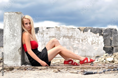 sexy blonde girl sitting on roof
