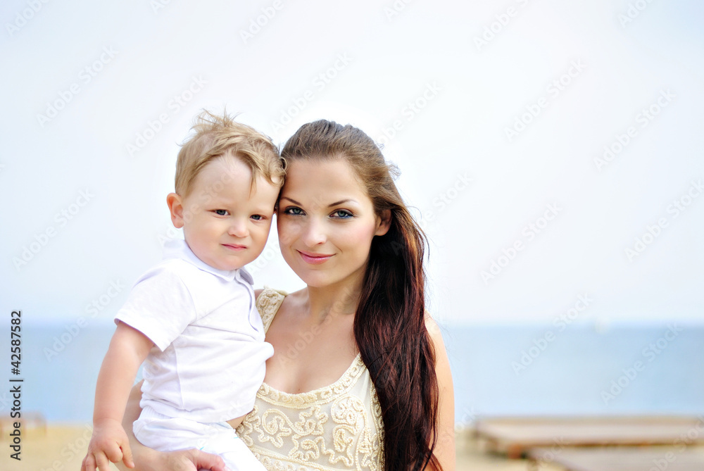 The little boy with mother on walk at the sea The little boy with mother on walk at the sea