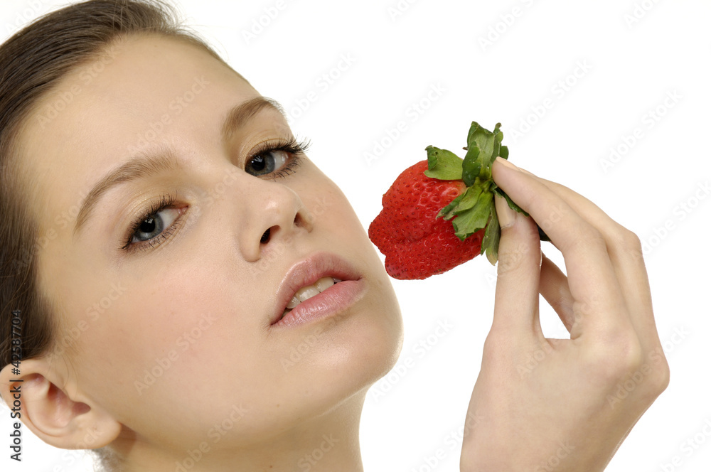 Pretty female model eating tasty strawberry Pretty female model eating tasty strawberry