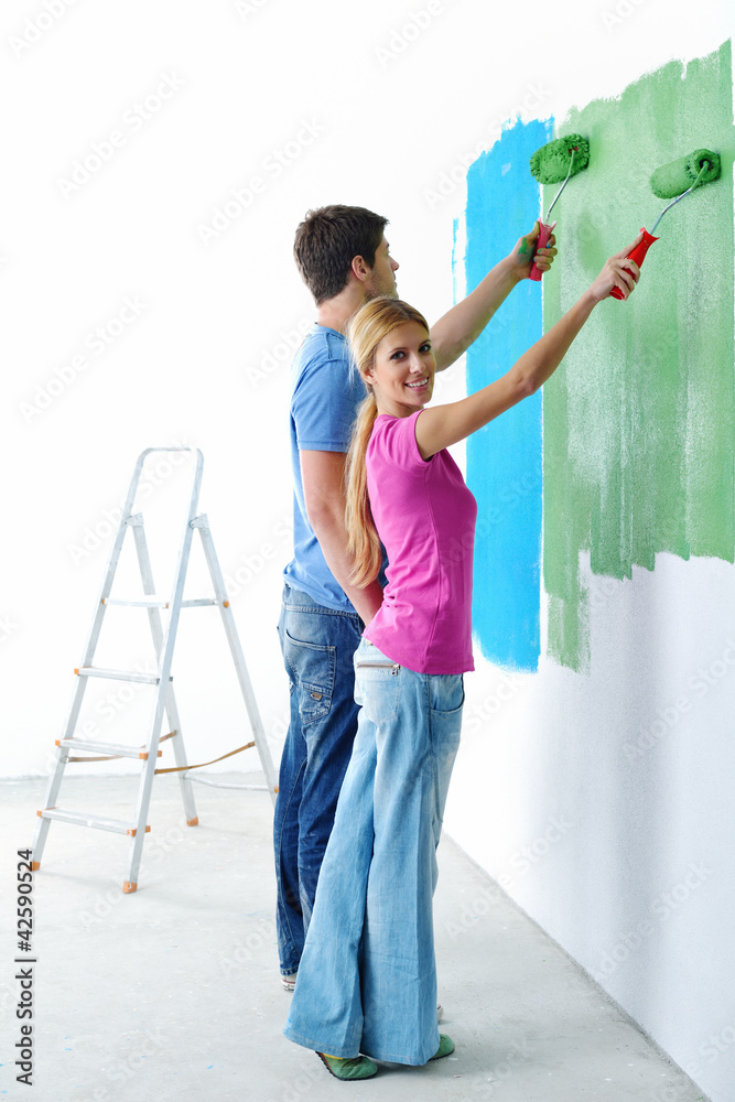 happy couple paint wall at new home happy couple paint wall at new home