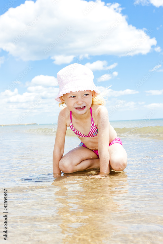 little girl on the beach at sea