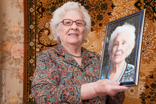Senior woman shows her portrait