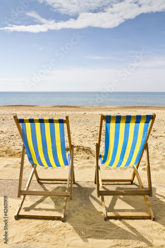 Two deck chairs on the beach © Chrispo