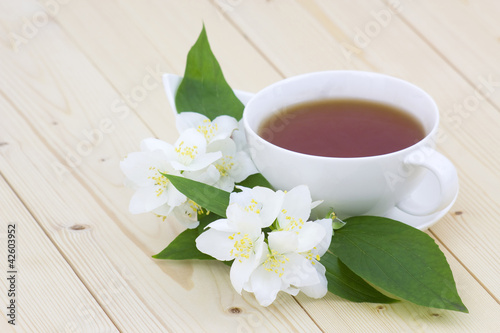 Cup of jasmine tea and jasmine flowers