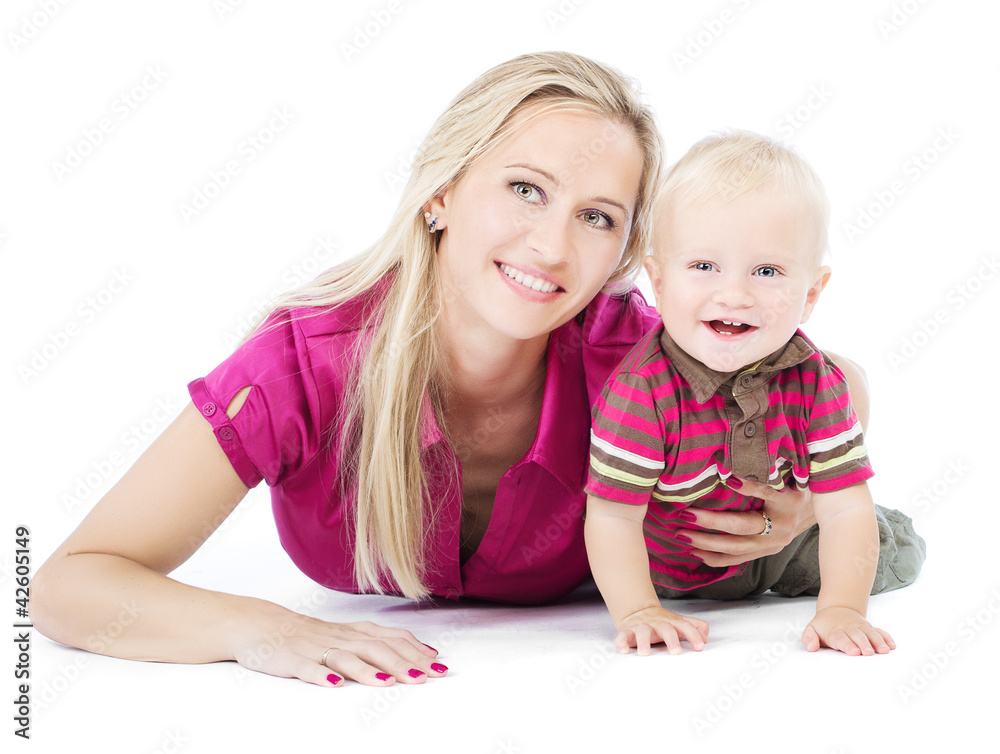 Happy mother playing with one year child lying on the floor Happy mother playing with one year child lying on the floor