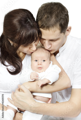 Parents kissing newborn baby, Family love