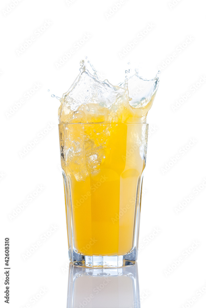 splash in glass of orange soda with ice cubes