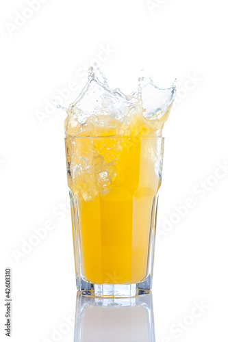splash in glass of orange soda with ice cubes