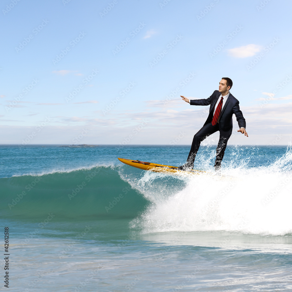 Young business person surfing on the waves Young business person surfing on the waves