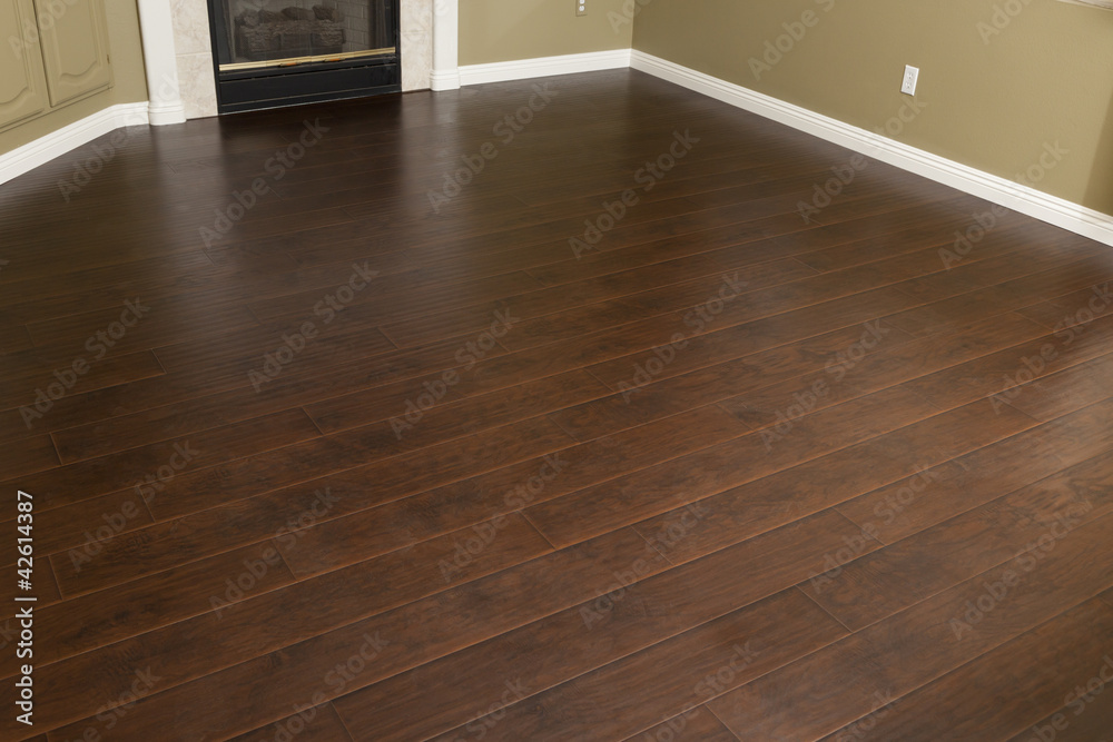 Newly Installed Brown Laminate Flooring and Baseboards in Home - obrazy, fototapety, plakaty 