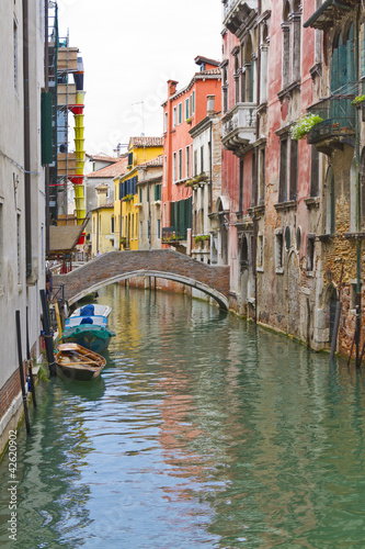 Traditional Venetian buildings along a water channel © dbrnjhrj