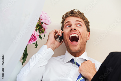 businessman with smartphone in a hotel room photo