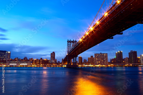Manhattan Bridge with skyline after sunset, New York