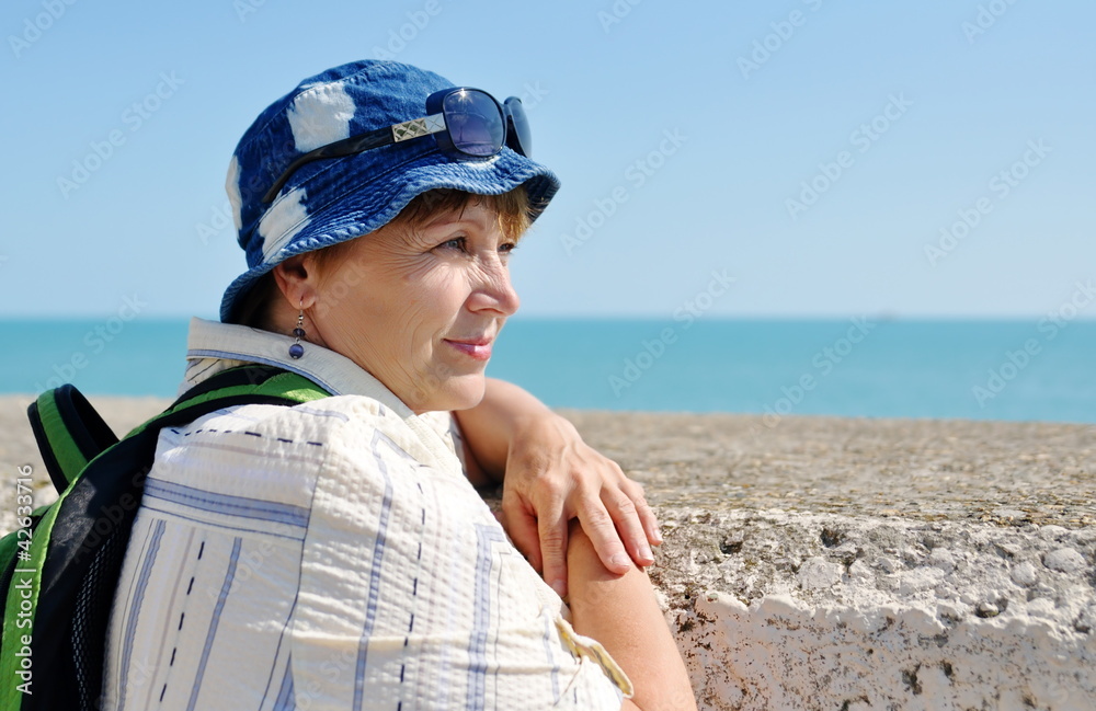 Senior female tourist looking away near the sea