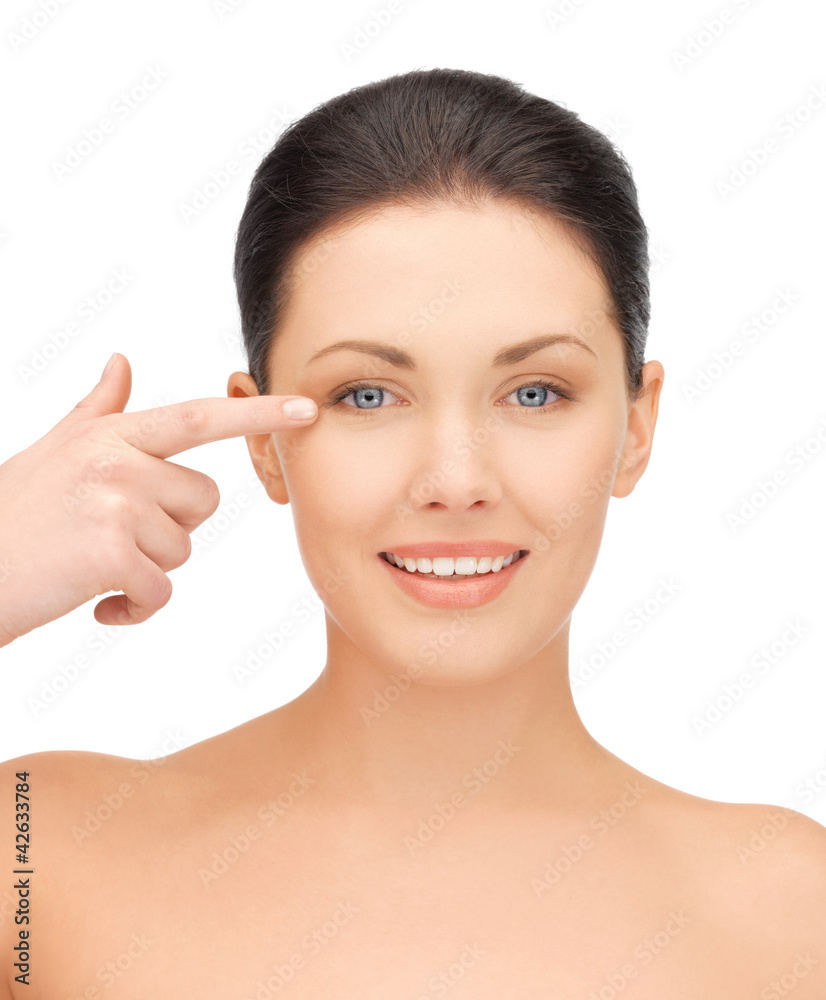 beautiful woman pointing to eye beautiful woman pointing to eye