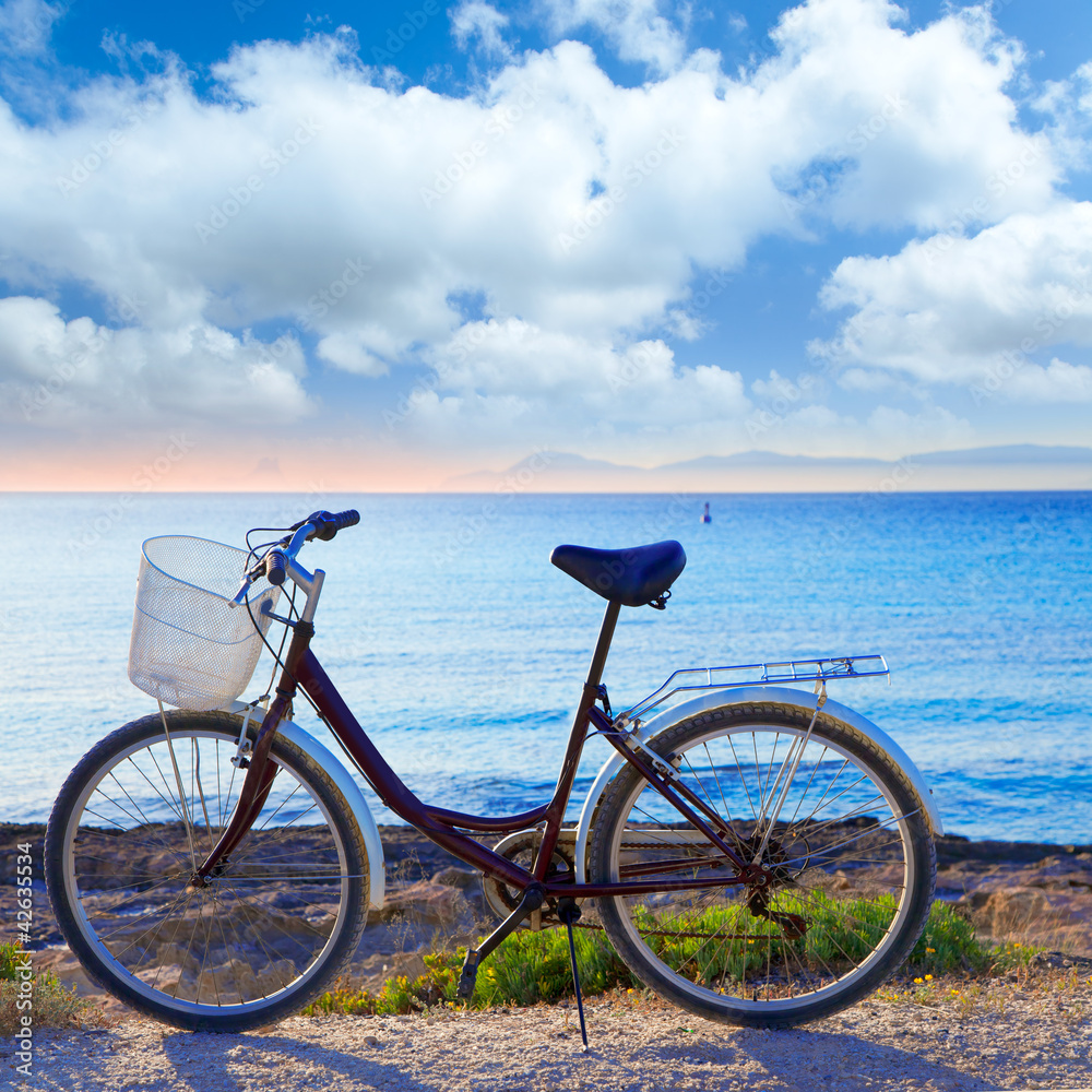 Fototapeta premium Bicycle in formentera beach with Ibiza sunset