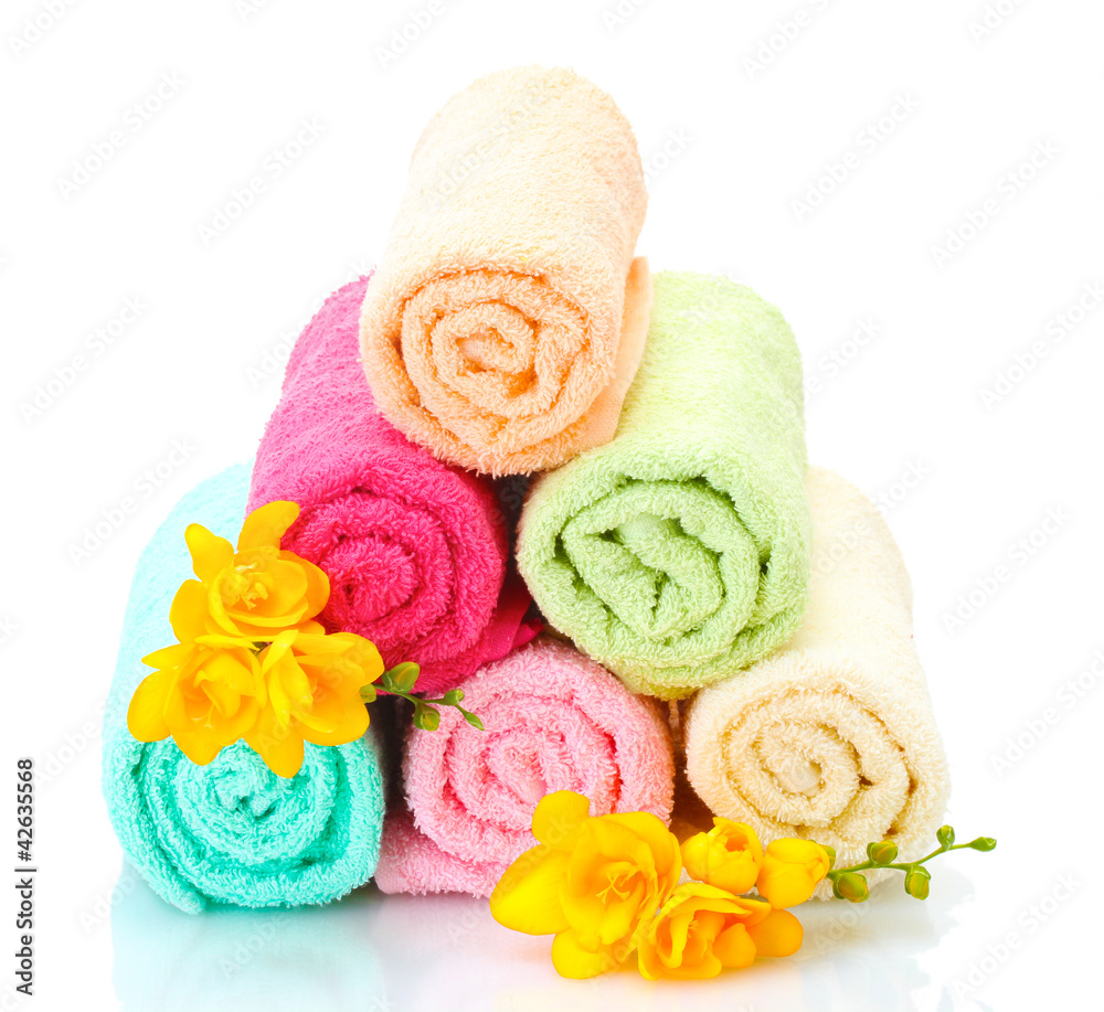 colorful towels and flowers isolated on white colorful towels and flowers isolated on white