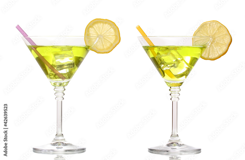 Yellow cocktail in martini glasses isolated on white Yellow cocktail in martini glasses isolated on white