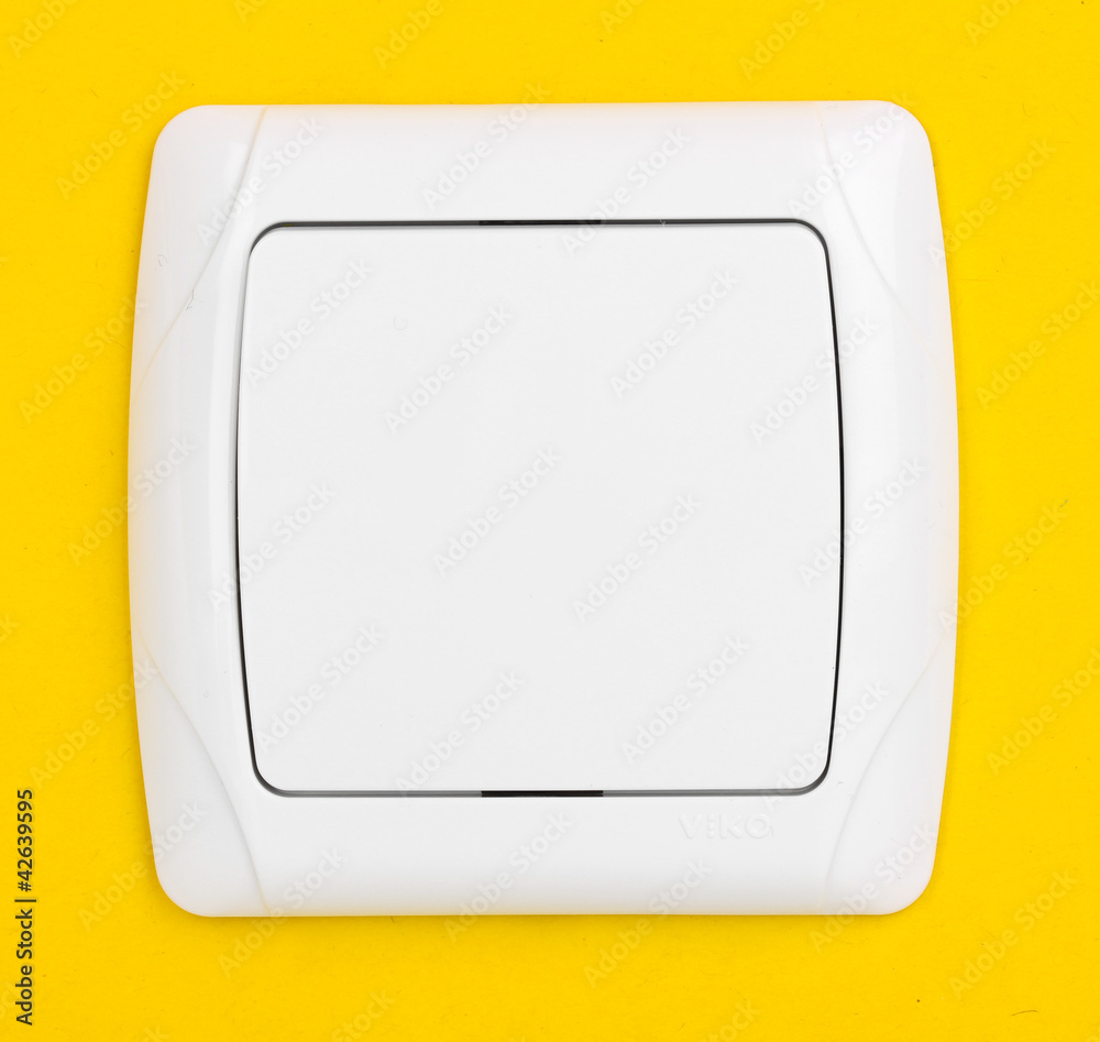 Modern light switch on yellow background Modern light switch on yellow background