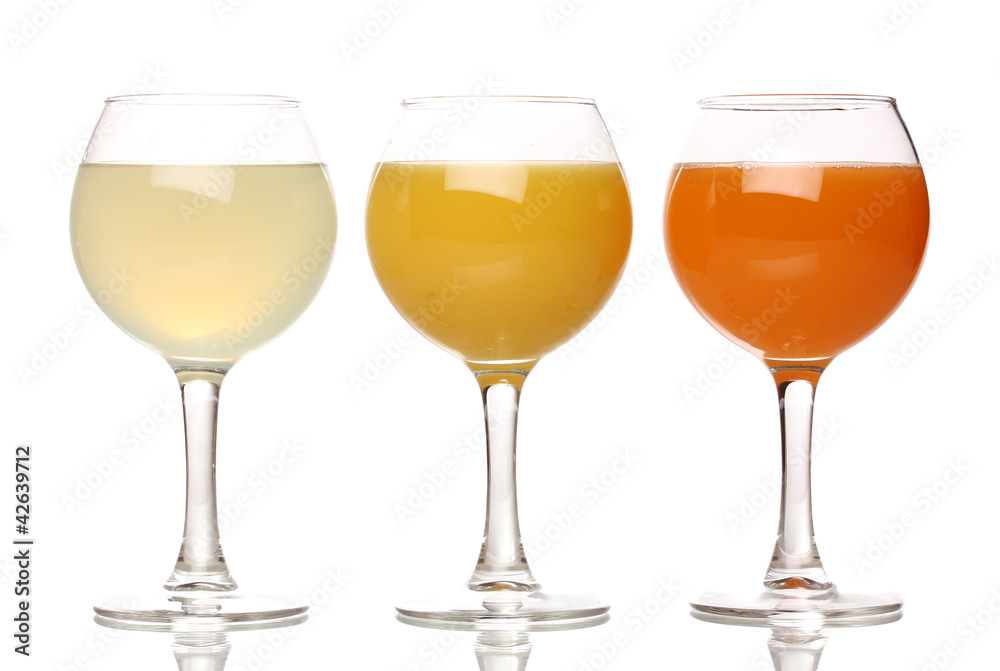 Tropical juices in glasses isolated on white Tropical juices in glasses isolated on white
