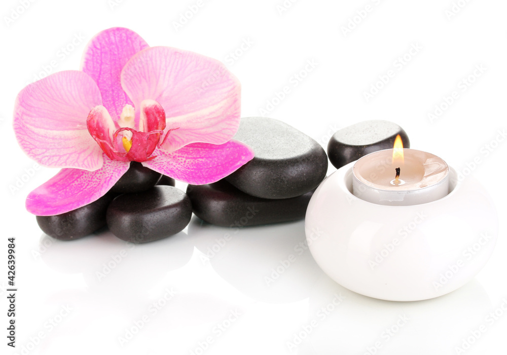 Spa stones with orchid flower and candle isolated on white Spa stones with orchid flower and candle isolated on white