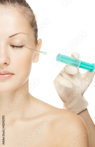 attractive young woman receives an botox injection 