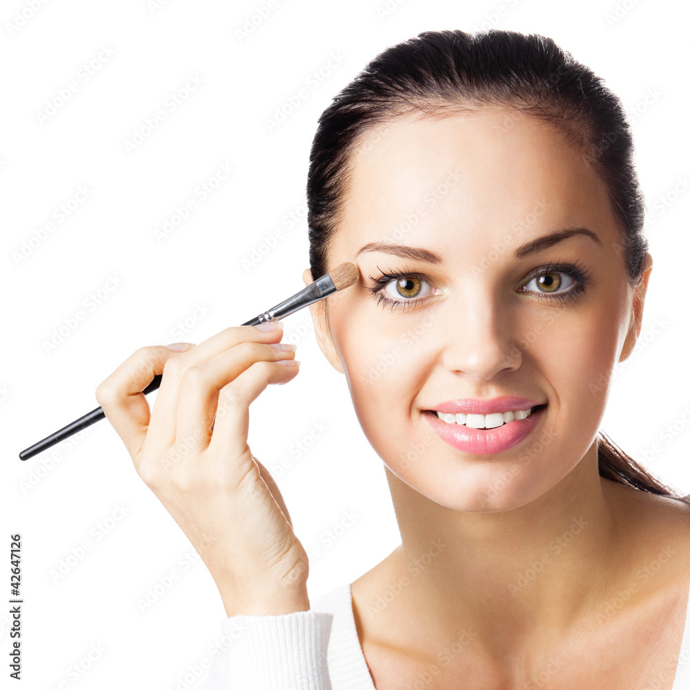 Woman applying eye shadow, by visage brush