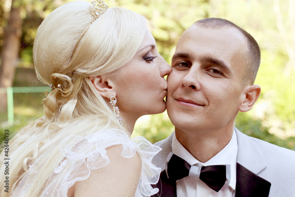 Bride kissing groom with love Bride kissing groom with love
