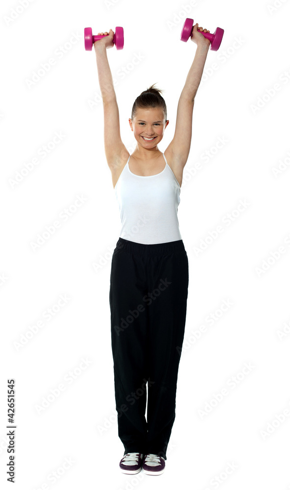 Young girl exercising with dumbbells Young girl exercising with dumbbells