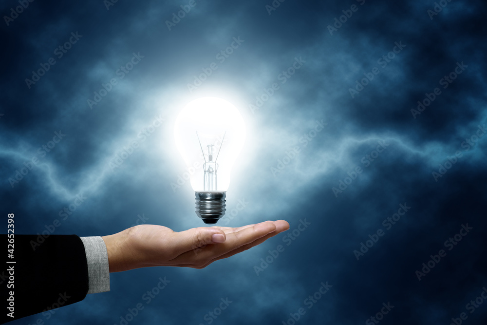 Light bulb hanging on business men Light bulb hanging on business men